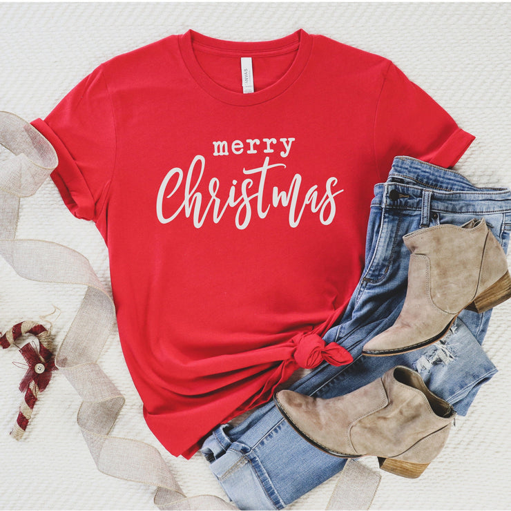 Red tee with white merry Christmas on tee jeans and boots next to tee