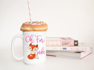 Oh, for fox sake in pink text featuring a orange and tan fox with sassy folded arms and eyes closed on a 15 oz ceramic mug with a donut on top and books in background