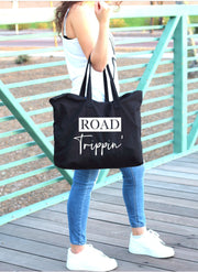 Road trippin' white words on large black tote bag alternate view showing in use