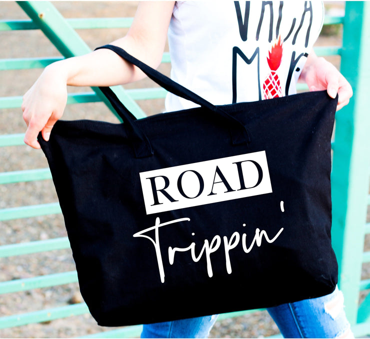Road trippin' white words on large black tote bag close up view