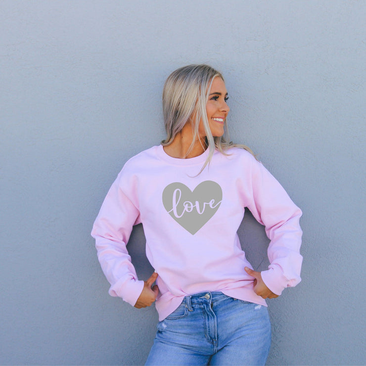 Love in grey heart on a pink crewneck sweatshirt