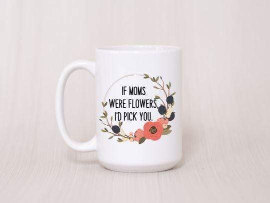 close up peach background white ceramic coffee mug with coral and olive wreath with quote in center 