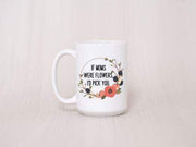 peach background white ceramic coffee mug with coral and olive wreath with quote in center 